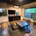 Livemax Resort Hakone Ashinoko room with low table, floor seating and large window view in Hakone