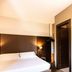 Sweet Hotel in Schiavon guest room with a neatly made bed and wall-mounted bedside lamps