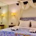 Great Greece Le Convivial Suites in Xylókastro: canopy bed with blue floral bedding and mirrored wall