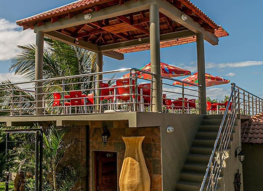 Ossanzaia Bilene Lodge in Bilene with a rooftop terrace, red seating, and outdoor stairs