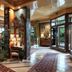 Hotel de la Ville Monza lobby with ornate seating, polished floors and garden-view glass doors