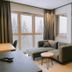 Waldhotel am Notschreipass in Todtnau guest room with sofa, desk and snowy forest view