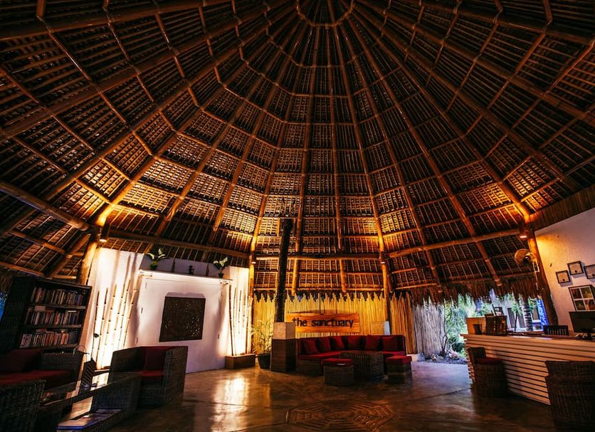 Atmosphere Resorts & Spa in Dauin features a rustic bamboo-roofed lounge with warm lighting and seating