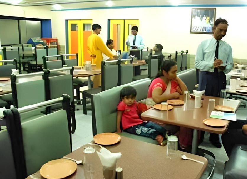 Hotel Bhagyalaxmi in Shirdi dining area with guests seated at tables and staff serving