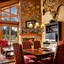 Faraway Jackson Hole in Teton Village: cozy lodge-style lounge with stone fireplace and mountain-view windows