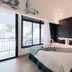 Sabai Mansion Pool & Spa in Krabi: bedroom with king bed, balcony doors and black accent wall