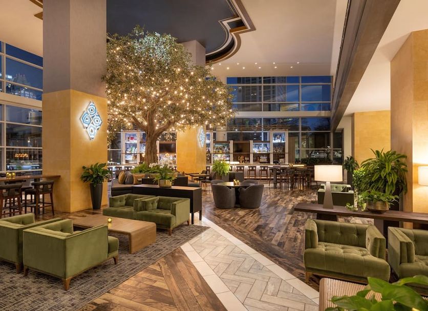 Fairmont Austin Gold Experience lobby lounge in Austin with a lit indoor tree and seating area