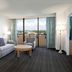 Embassy Suites by Hilton Tampa Airport Westshore suite with balcony view over Tampa and seating area
