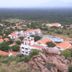 Kadambavanam Ethnic Village Resort in Madurai with red-roofed villas, pool, and hillside view