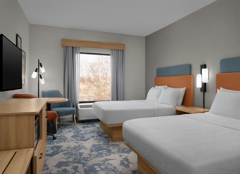 Hampton Inn Crossville guest room with two beds, window view, desk and chair
