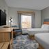 Hampton Inn Crossville guest room with two beds, window view, desk and chair