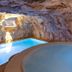 L'Antico Uliveto in Potenza Picena: indoor cave-style pool with rock walls and round whirlpool