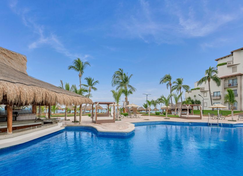 Fiesta Americana Cancun Villas in Cancún with palm-lined pool and beachside view