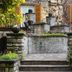 Hotel San Pancrazio in Trescore Balneario: stone courtyard steps with fountain, greenery and shuttered windows