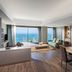 Liberty Kusadasi suite with sea view, dining area, and balcony overlooking Kusadasi