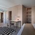 123 Mainstreet Boutique Hotel in St. Julian's room with built-in wardrobes, desk, and striped rug