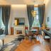 The Editory Riverside Hotel, Lisbon guest room with dining table, desk and tall windows