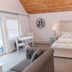 Inn On Peaks Island guest room with king bed, seating area, and balcony doors in Peaks Island