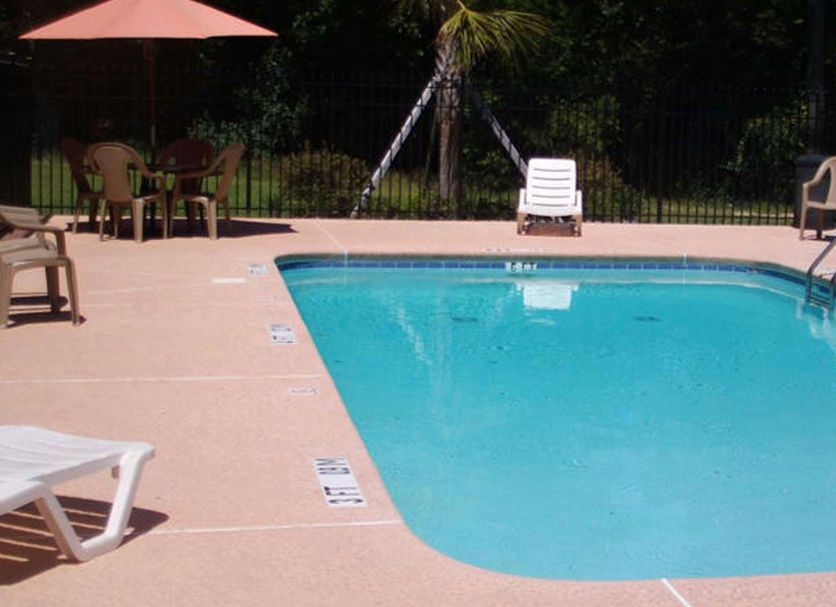 Western Motel Inn and Suites Hazlehurst outdoor pool with lounge chairs and patio seating in Hazlehurst