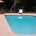 Western Motel Inn and Suites Hazlehurst outdoor pool with lounge chairs and patio seating in Hazlehurst