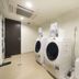 Laundry room at Daiwa Roynet Hotel Yokohama-Koen in Yokohama with two front-load washers and a sink