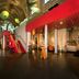 Kruisherenhotel Maastricht lobby with vaulted arches, red staircase, and dramatic modern lighting