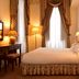 Pousada Palácio de Queluz guest room with double bed, lamps, and draped window in Queluz