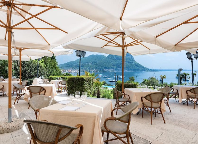 Hotel Du Parc, Garda terrace dining with lake and mountain views under white umbrellas