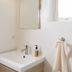 Vallakot Farm Guesthouse, Laugar: compact bathroom sink with mirror, soap dispenser, and towel ring