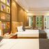 Sterling Amargarh Jodhpur hotel room in Jodhpur with twin beds, desk, and balcony doors to greenery