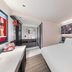 ibis Beijing Dacheng Road guest room with bed, desk, mirror, and colorful wall art in Beijing
