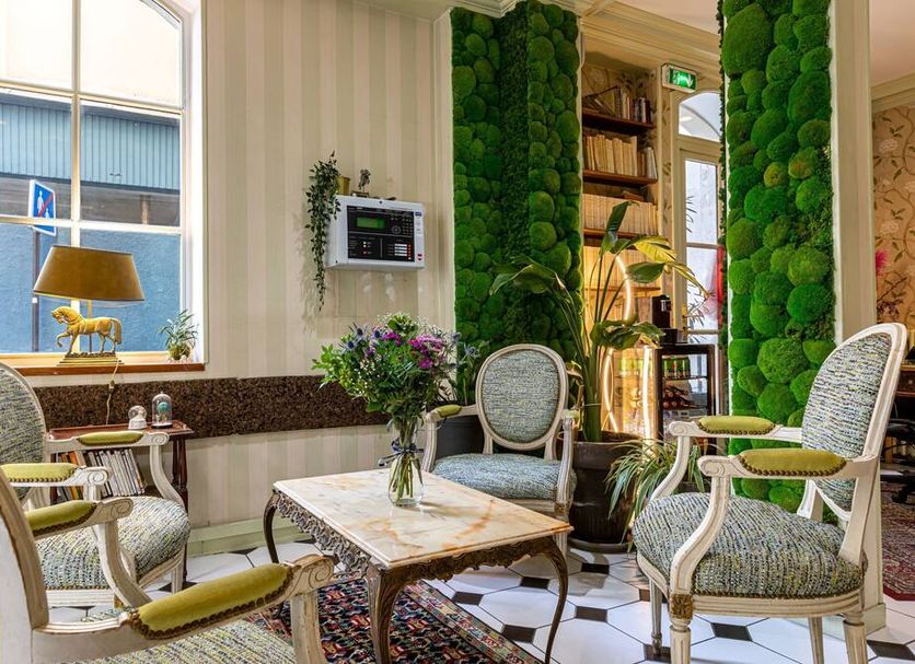 Hotel Romance Malesherbes by Patrick Hayat lounge in Paris with upholstered chairs and marble table