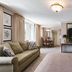 The Kimball at Temple Square guest suite in Salt Lake City with sofa, dining area, and large mirror