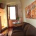 B&B Gildo Trani guest room with sofa, table by window, and wall art in Trani