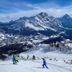 Th Cadore - Hotel Antelao in Borca di Cadore with skiers on a snowy mountain slope and alpine peaks