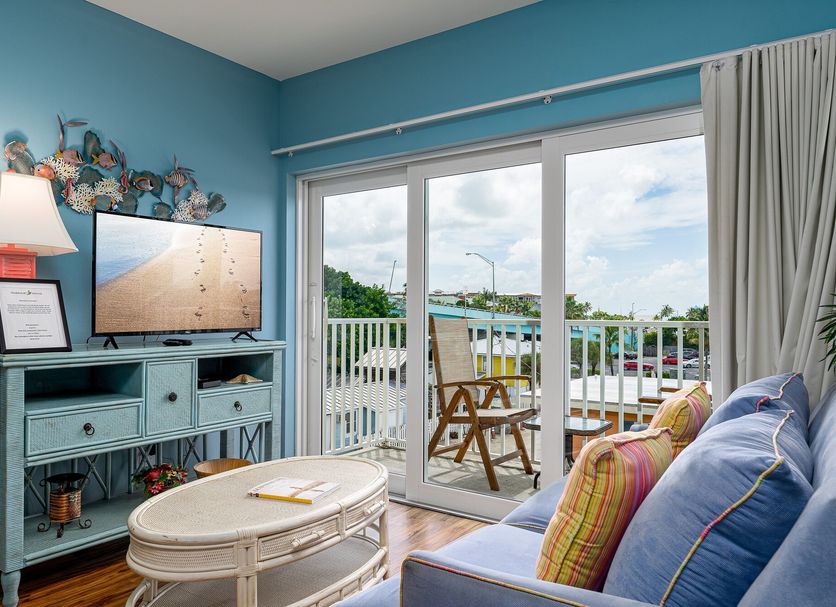 Harbour House At The Inn in Fort Myers Beach room with balcony, ocean-view sliding doors and seating area