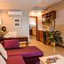 Le Plaza Hotel in Port Au Prince lounge with purple sofa, desk, wall art and potted plant