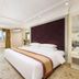Dalian Jinbai International Hotel guest room with king bed and city view in Dalian