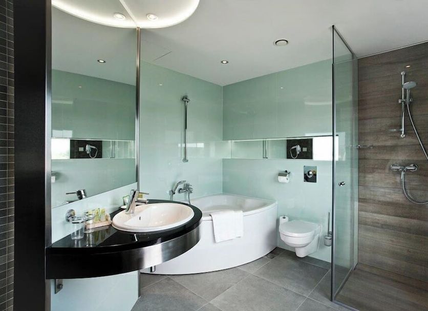Qubus Hotel Bielsko-Biala bathroom with soaking tub, glass shower and vessel sink in Bielsko-Biala