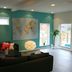 Flygplatshotellet in Härryda lounge with teal walls, black sofas, world map and tall windows