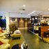 Fletcher Hotel Restaurant Amersfoort lounge with bar, piano and seating area in Amersfoort