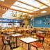 Comfort Hotel Hakata in Fukuoka café dining area with tables, chairs, and a bright skylit ceiling