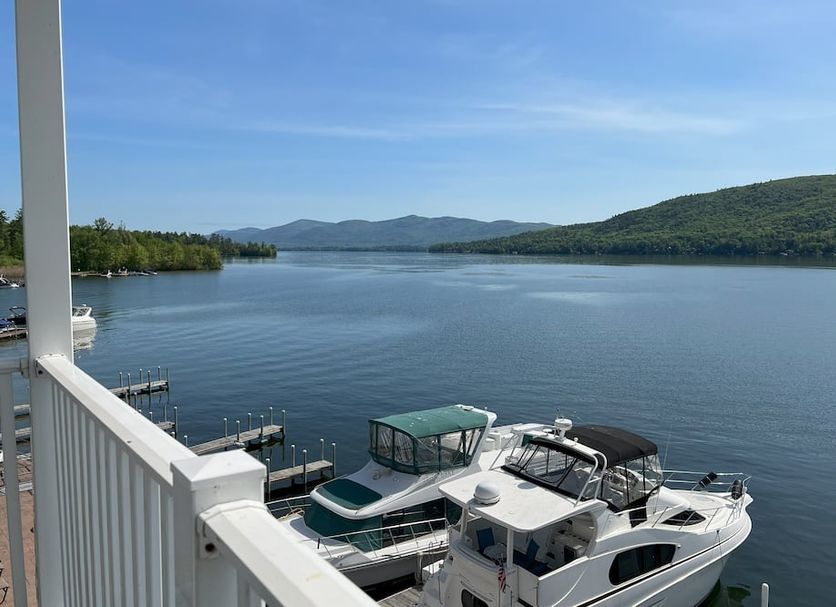 Georgian Lakeside Resort in Lake George with docked boats and calm lake and mountain views
