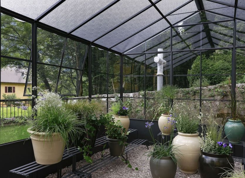 Annexe 1888 in Flaine: screened patio with potted plants and benches beside a garden view
