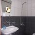 Fire pansiyon bathroom with wall-mounted sink, mirror, and shower in Cirali