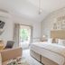 Bartley Lodge Hotel Southampton guest room with king bed, wall-mounted TV, and window view
