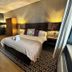 The Churchill Court in Woodstock guest room with king bed, patterned rug, bedside lamps and large window