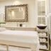 Banksia Boutique Hotel & Spa spa treatment room with massage table and ornate mirror, Cape Town