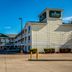 HomeTowne Studios by Red Roof Austin exterior with parking lot and clear blue sky