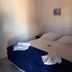 Pousada Ilha Morena in Florianopolis guest room with double bed, blue bed runner and folded towels